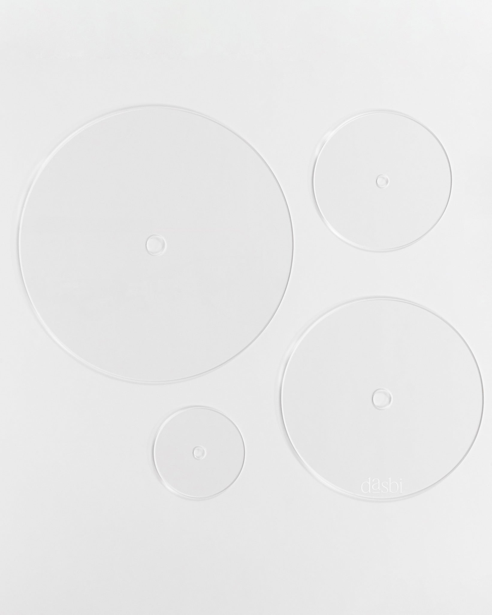 Food-safe acrylic cake board with central hole for tiered cakes.