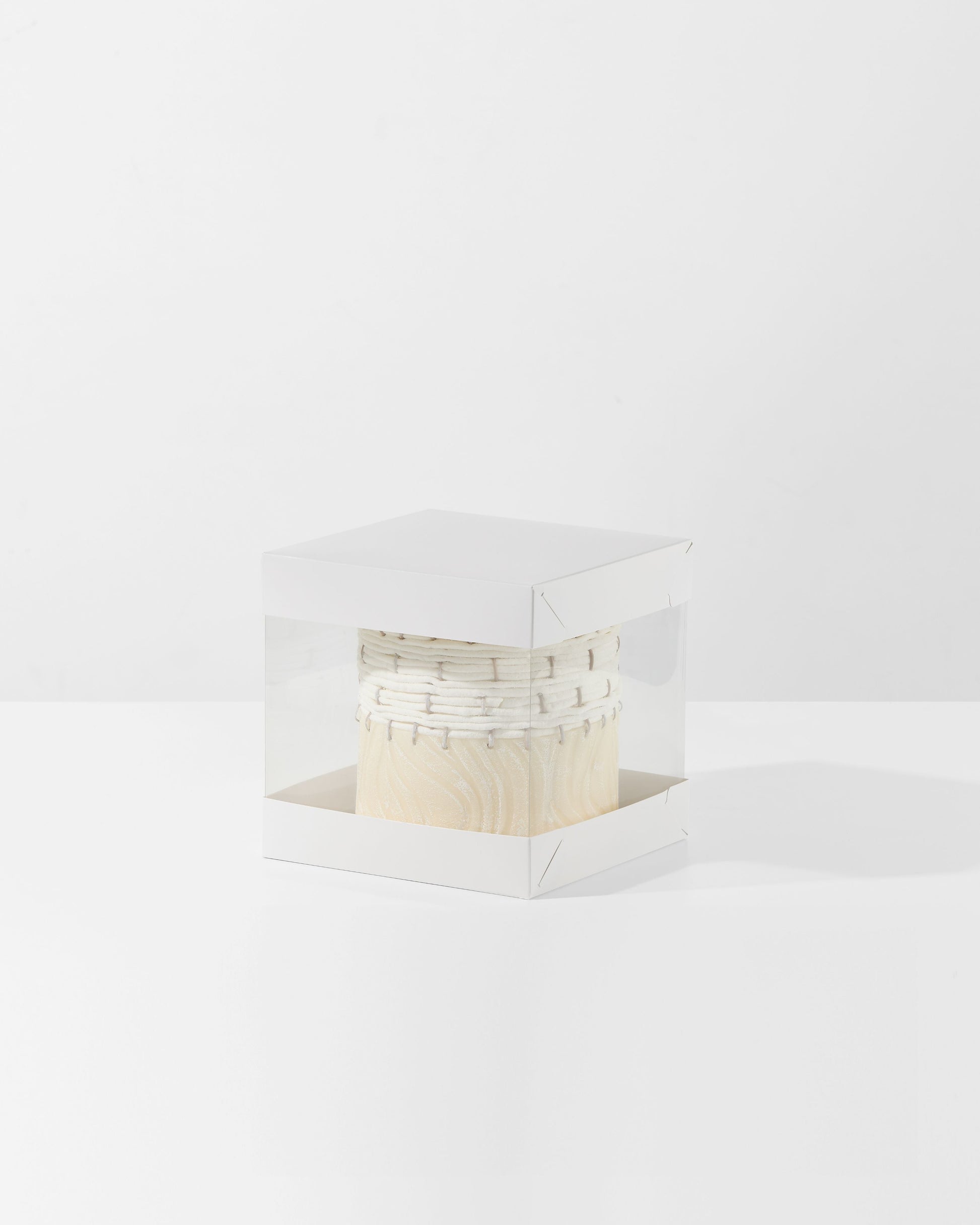 Small wooden box with a decorative lid on a white background