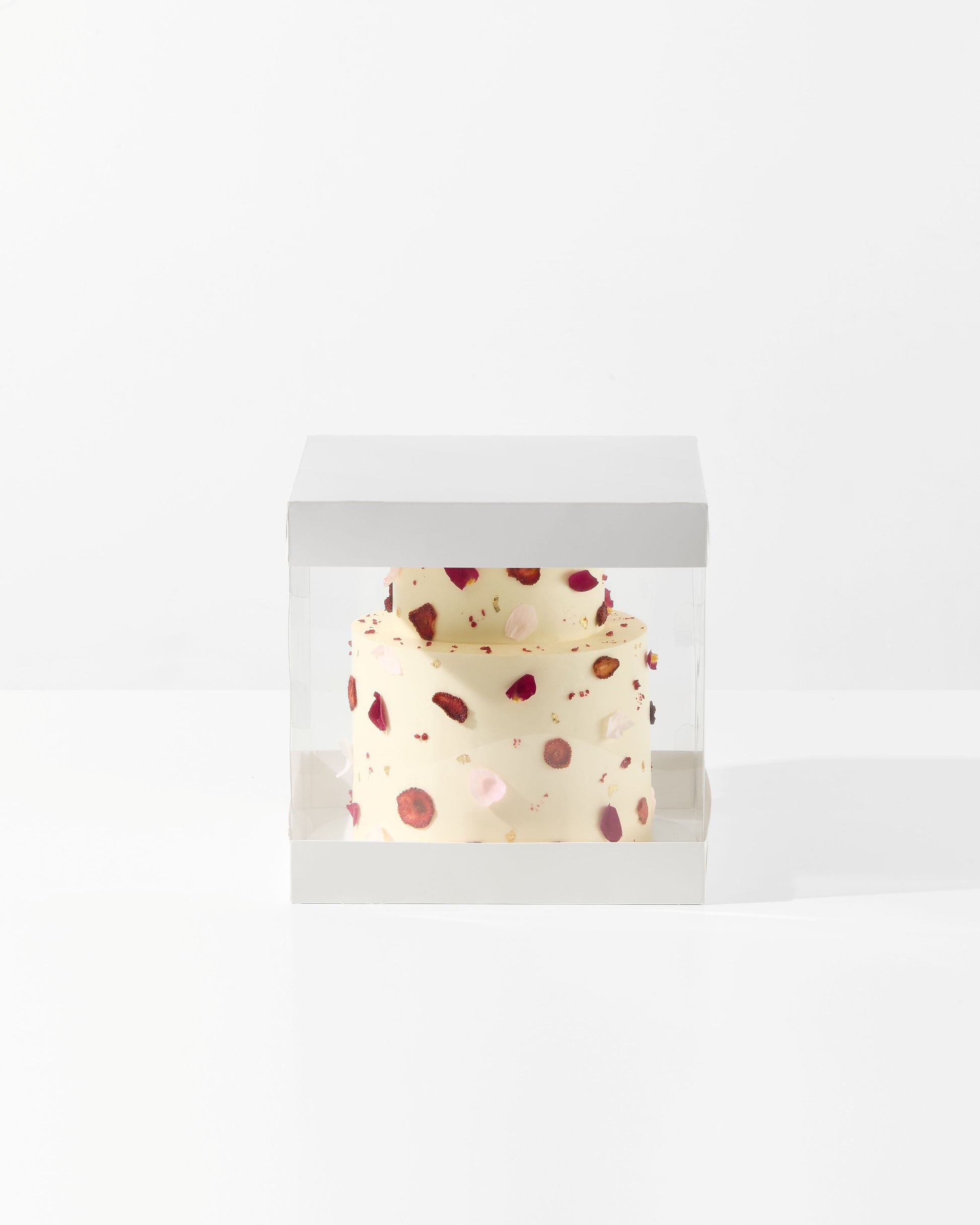 Small ceramic pot with red and brown polka dot pattern on a white background